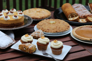 a table covered with apple and pumpkin pastries, decorated with pumpkins and apples