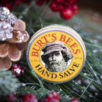 Burts Bees hand salve tin, amid greenery