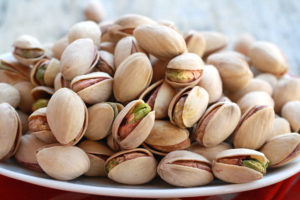 dish of pistachios in their shells