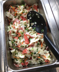 a metal bin with seafood salad