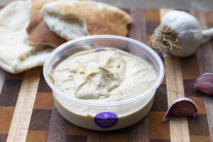 hummus with pita bread and garlic cloves
