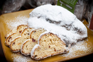slices of stollen bread on a table, dusted with powdered sugar
