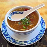 a bowl of hearty looking soup with green onions sprinkled on top
