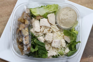 salad with chicken, parmesan gratings, and croutons on top