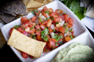 a dish of salsa with chips