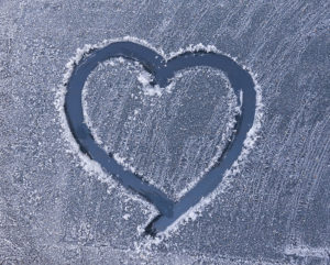 heart drawn on frosty window