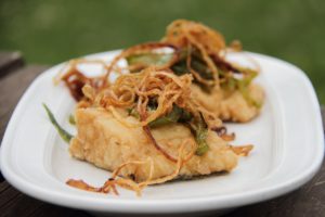 caramelized onions atop some kind of breaded meat (possible fish)