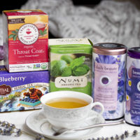 a group of boxes and canisters of tea and a cut of tea