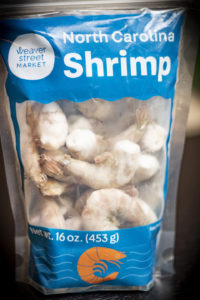 a bag of raw shrimp with a Weaver Street label