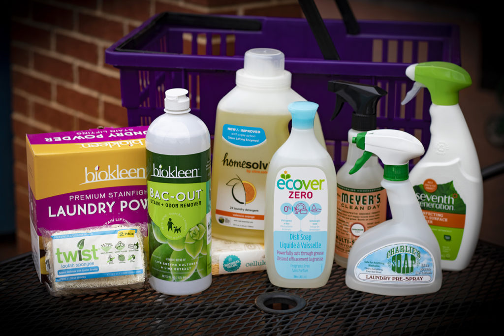 bottles of cleaners and a shopping basket