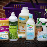 bottles of cleaners and a shopping basket