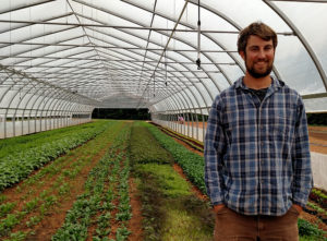 Brett in hoophouse at Red Hawk Farm