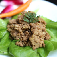 tempeh on a leaf of lettuce on a plate