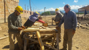 architect with workers at table in the construction site