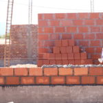 brick wall with rebar sticking up