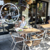 people sitting at tables with food in front of A Place at the Table restaurant