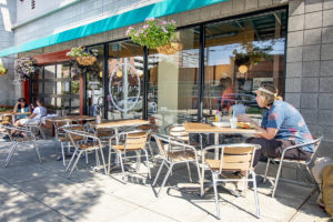 man with bags eating outside A Place at the Table