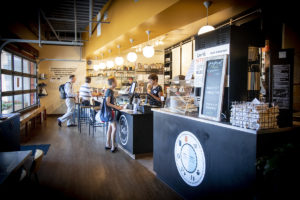 counter in restaurant with people ordering food and eating