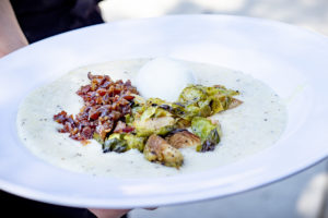 grits topped with brussels sprouts, bacon, and a boiled egg