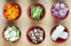 Japche ingredients in bowls: noodles and cut raw vegetables