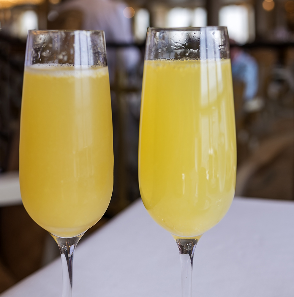 Champagne and orange juice create a mimosa.